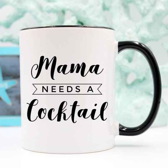 A humorous coffee mug with the text 'Mama Needs A Cocktail', showcasing a fun design perfect for Mother's Day gifts.