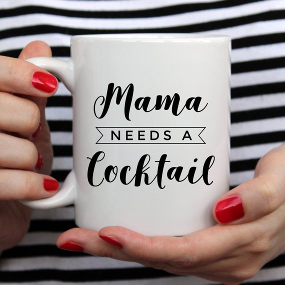 A humorous coffee mug with the text 'Mama Needs A Cocktail', showcasing a fun design perfect for Mother's Day gifts.