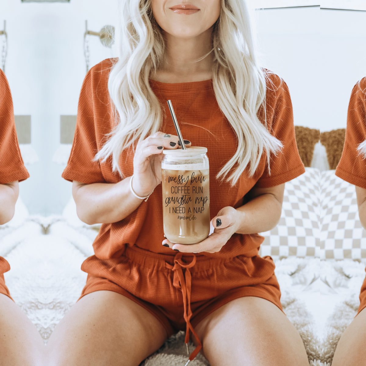 A stylish Messy Bun glass drinking cup with a bamboo lid and stainless steel straws, perfect for hot and cold beverages.