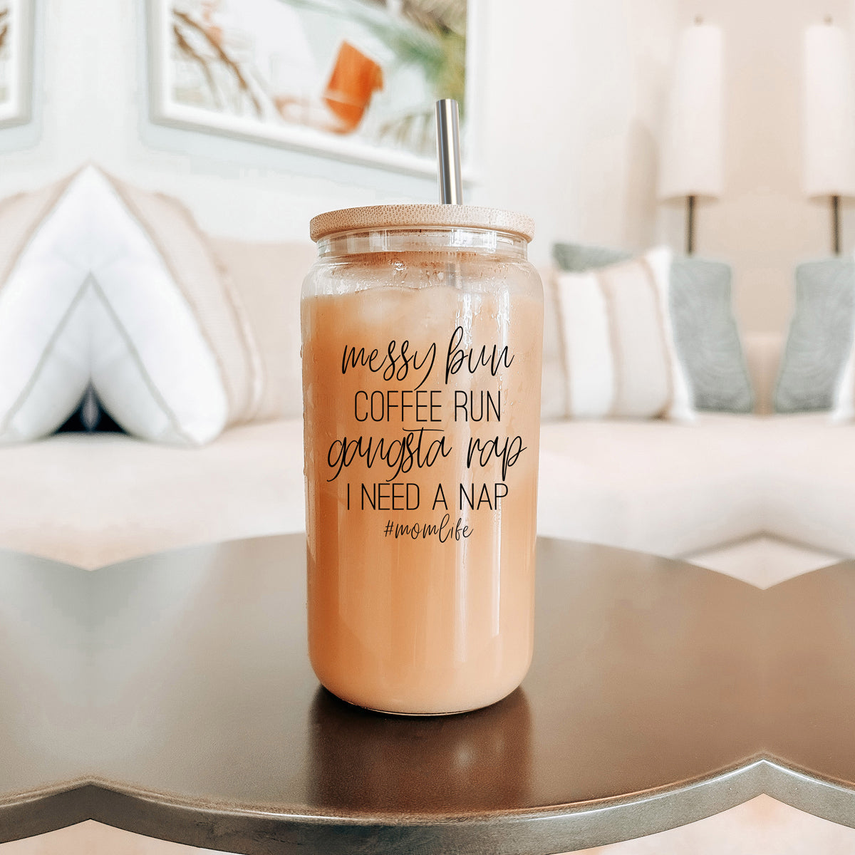 A stylish Messy Bun glass drinking cup with a bamboo lid and stainless steel straws, perfect for hot and cold beverages.