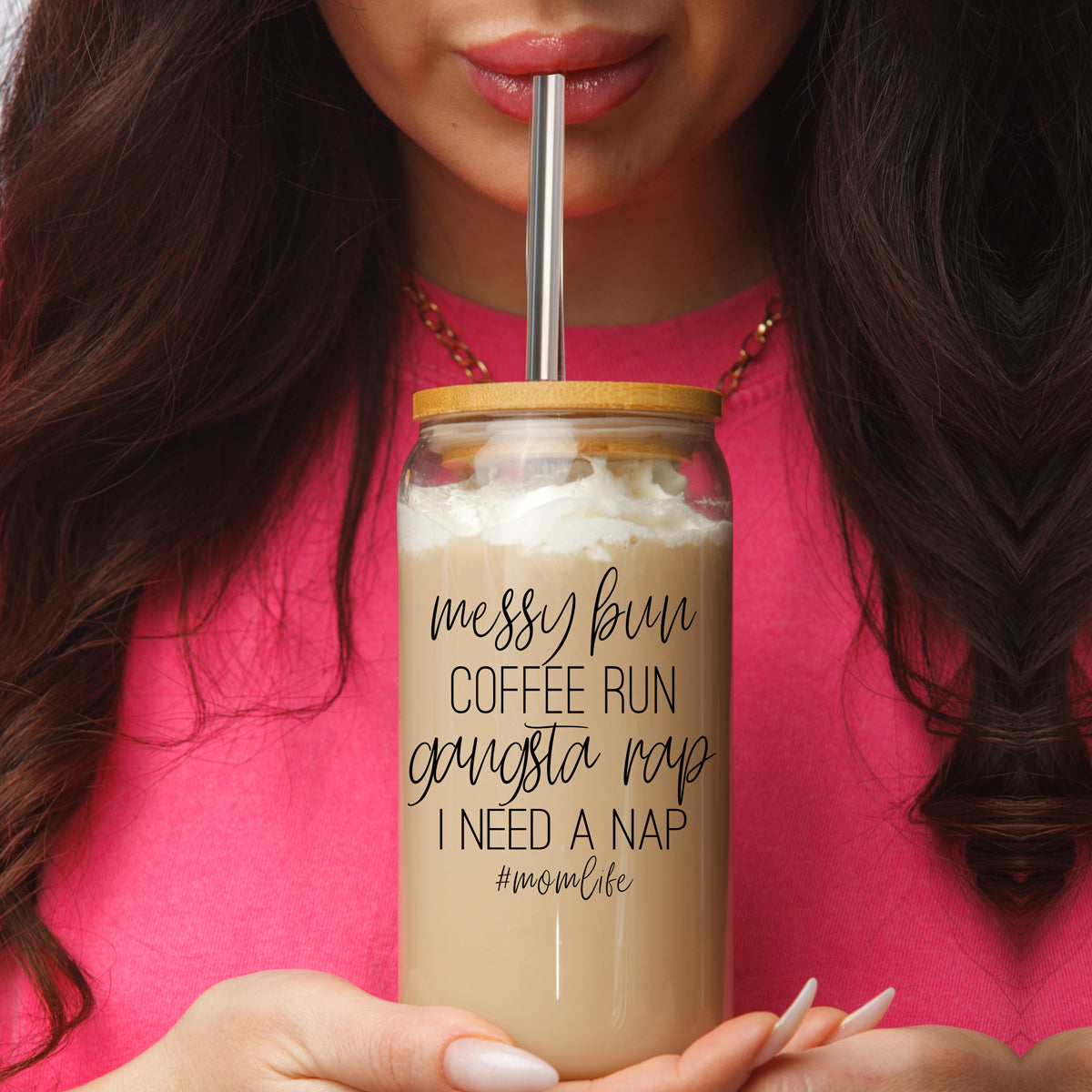 A stylish Messy Bun glass drinking cup with a bamboo lid and stainless steel straws, perfect for hot and cold beverages.