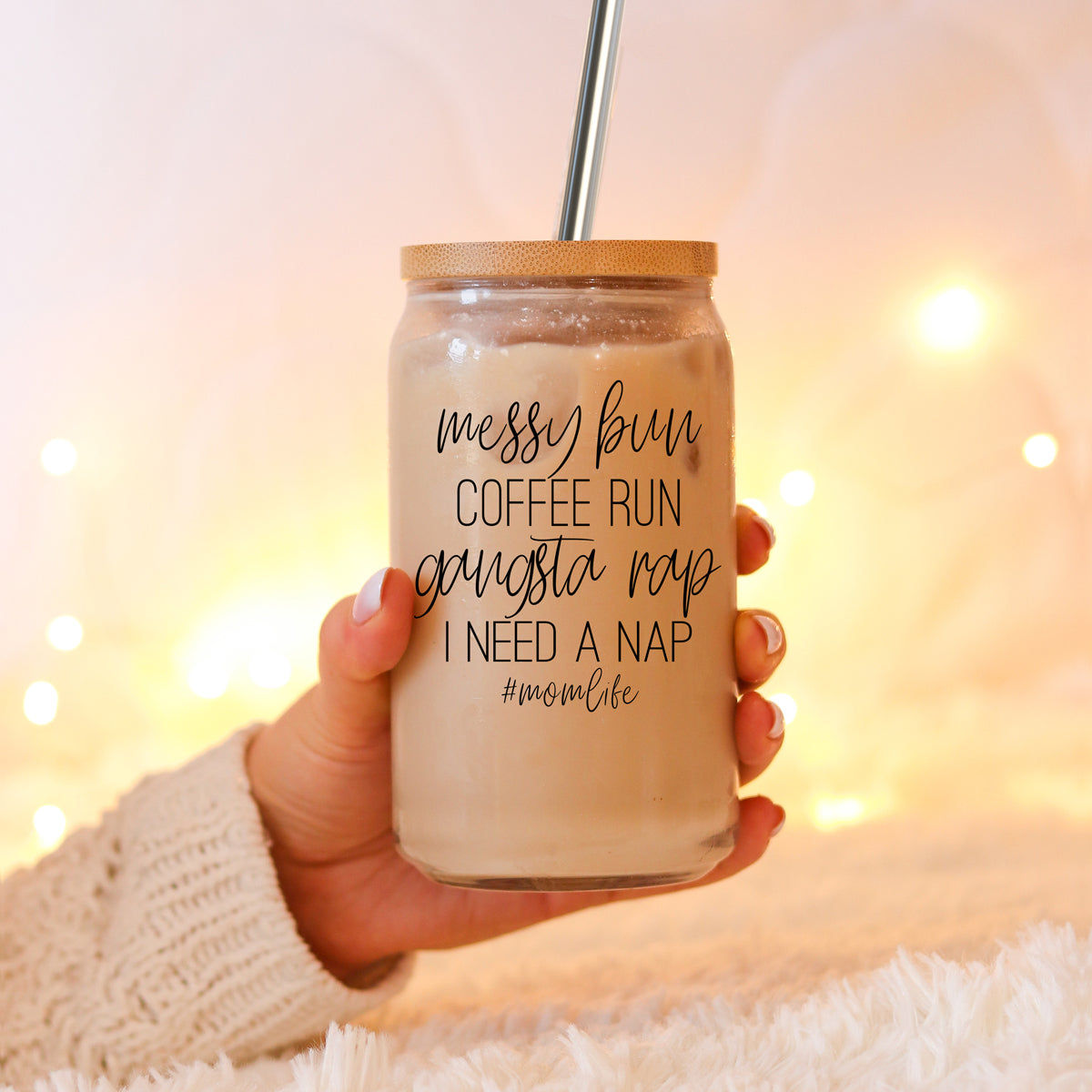 A stylish Messy Bun glass drinking cup with a bamboo lid and stainless steel straws, perfect for hot and cold beverages.