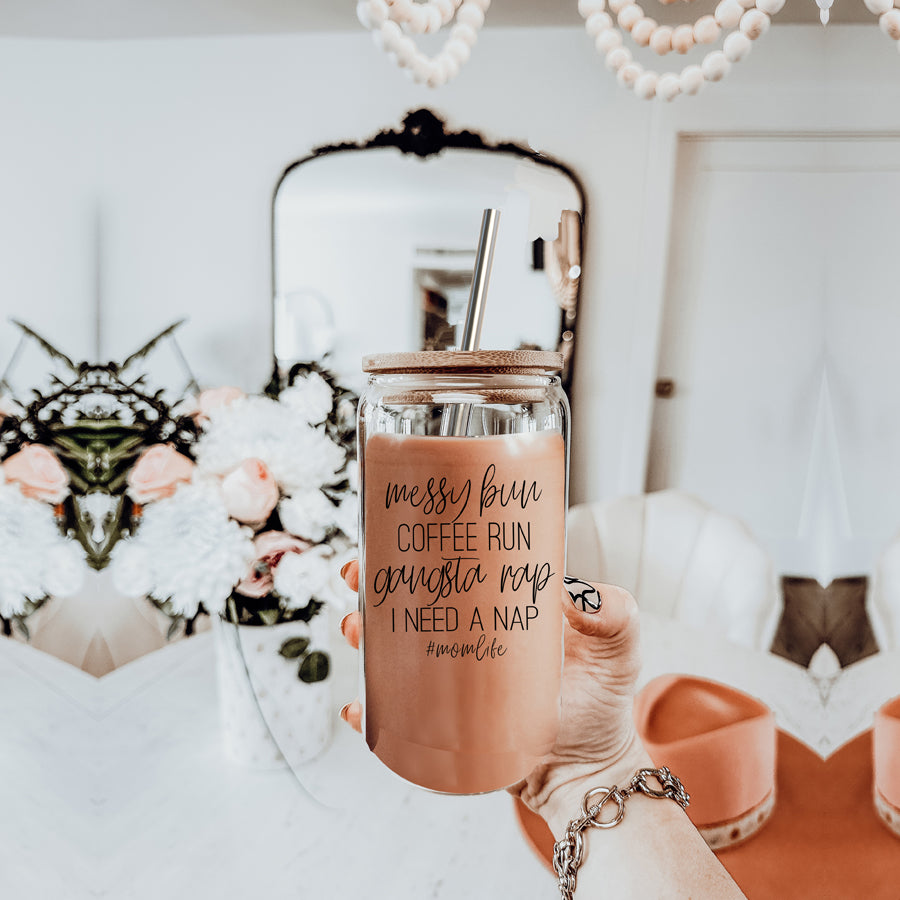 A stylish Messy Bun glass drinking cup with a bamboo lid and stainless steel straws, perfect for hot and cold beverages.