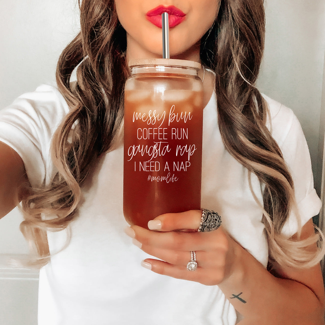 A stylish Messy Bun glass drinking cup with a bamboo lid and stainless steel straws, perfect for hot and cold beverages.