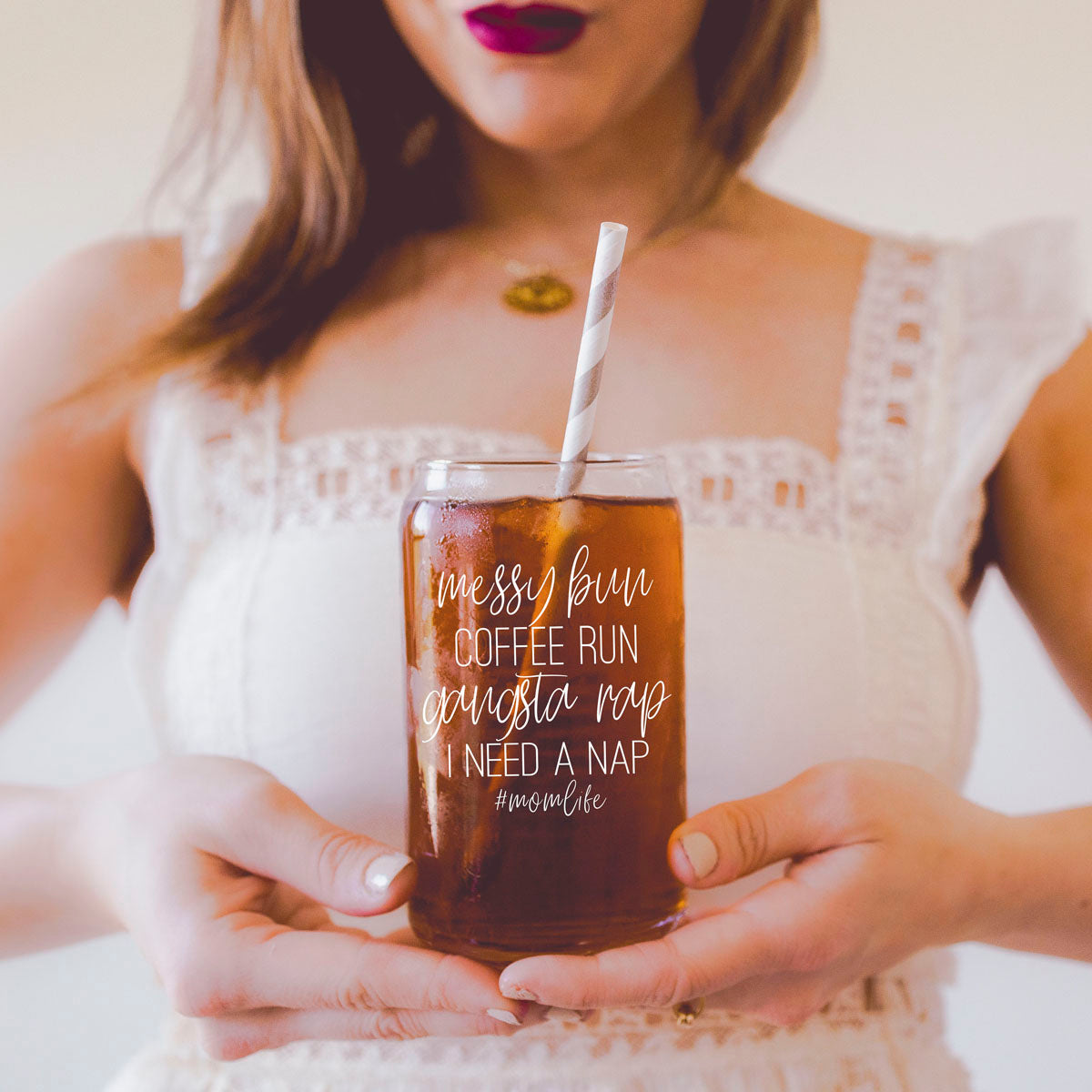 A stylish Messy Bun glass drinking cup with a bamboo lid and stainless steel straws, perfect for hot and cold beverages.