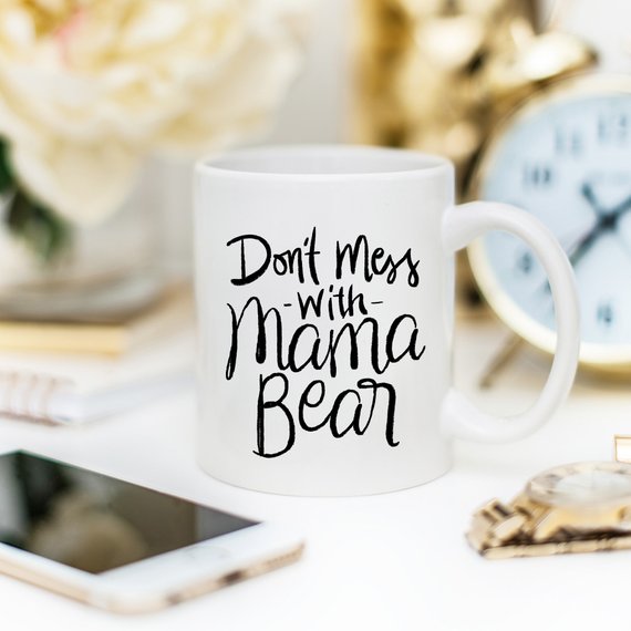 A humorous coffee mug featuring the phrase 'Don't Mess With Mama Bear', crafted from high-quality ceramic, perfect for moms.