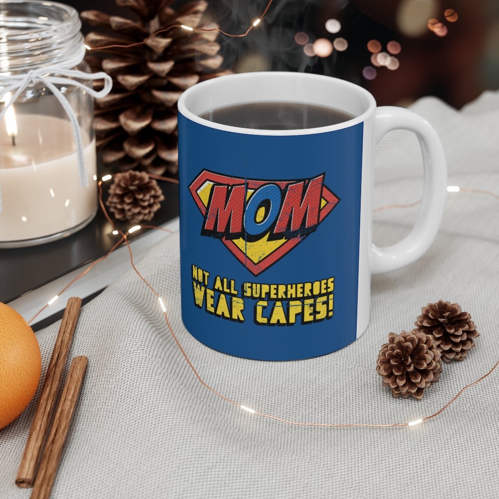 A white ceramic mug featuring the phrase 'Not All Superheroes Wear Capes' with a superhero theme, perfect for coffee or tea.