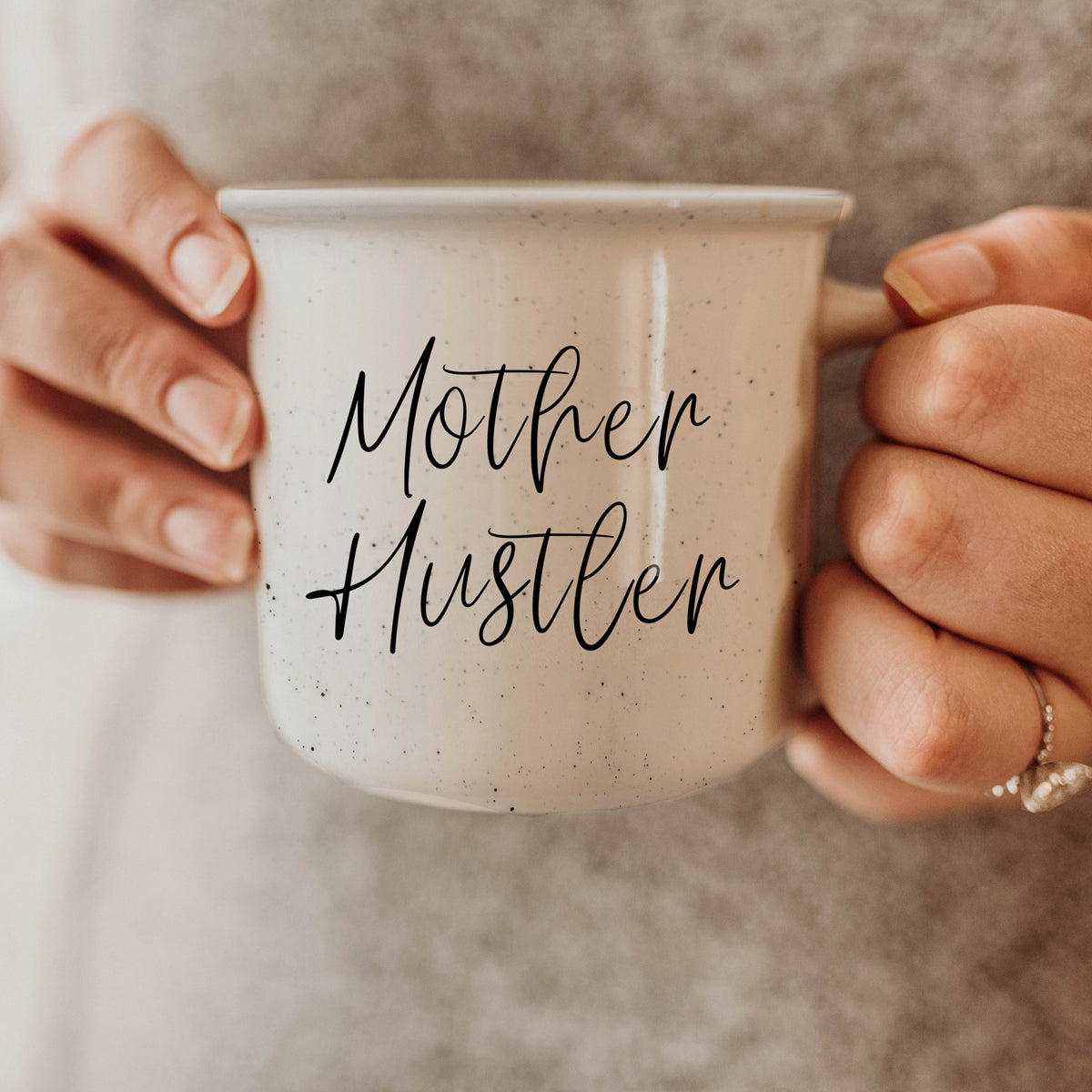 Mother Hustler 14.5oz ceramic campfire mug with white sesame glaze and black lettering, designed for busy moms.