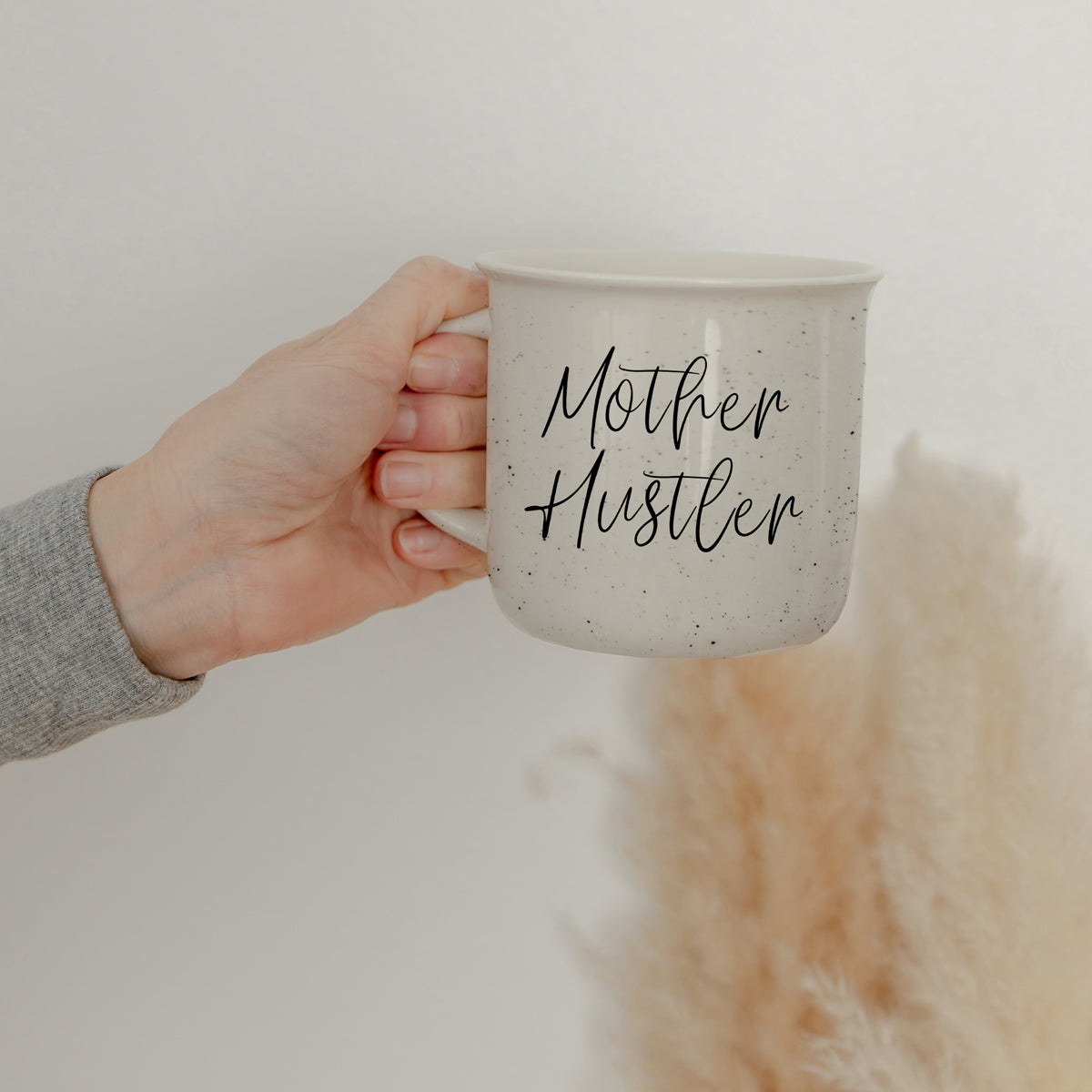 Mother Hustler 14.5oz ceramic campfire mug with white sesame glaze and black lettering, designed for busy moms.