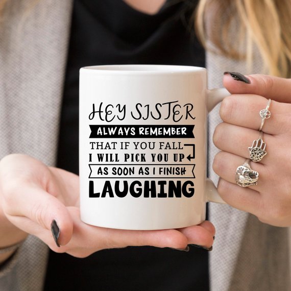 Funny coffee mug for sisters with a humorous quote, featuring a vibrant design on a white ceramic background.