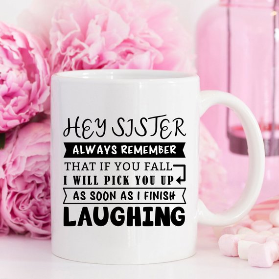 Funny coffee mug for sisters with a humorous quote, featuring a vibrant design on a white ceramic background.