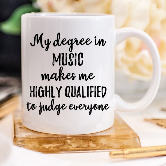 A stylish white ceramic Music Mug featuring vibrant designs on both sides, perfect for musicians and music lovers, showcasing its high-quality craftsmanship.