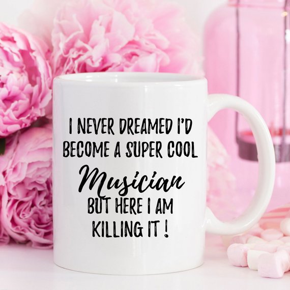 A stylish white ceramic mug featuring a vibrant music-themed design, perfect for musicians and music lovers, showcasing both front and back prints.