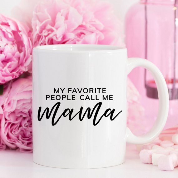 A humorous coffee mug with the phrase 'My Favorite People Call Me Mama' printed on it, showcasing a fun design perfect for Mother's Day.