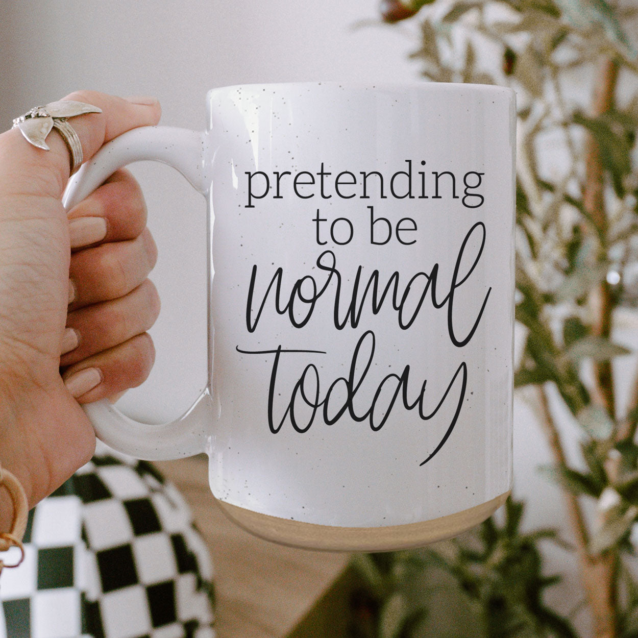 A 16oz off-white ceramic mug with dark speckles, featuring the humorous text 'Pretending to be Normal Today' on both sides.