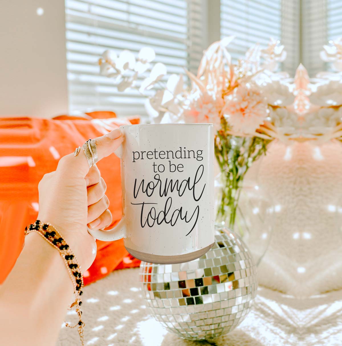 A 16oz off-white ceramic mug with dark speckles, featuring the humorous text 'Pretending to be Normal Today' on both sides.