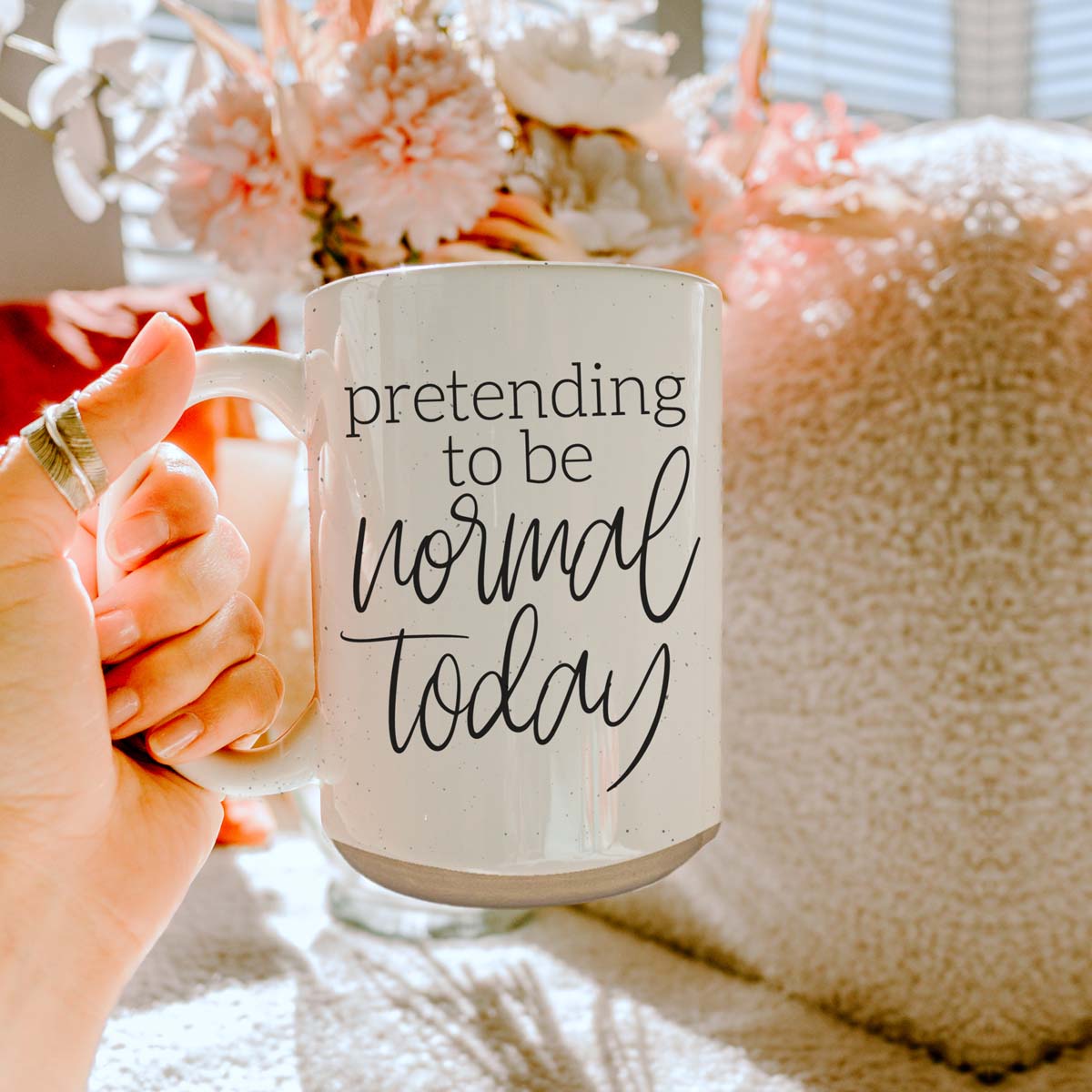 A 16oz off-white ceramic mug with dark speckles, featuring the humorous text 'Pretending to be Normal Today' on both sides.