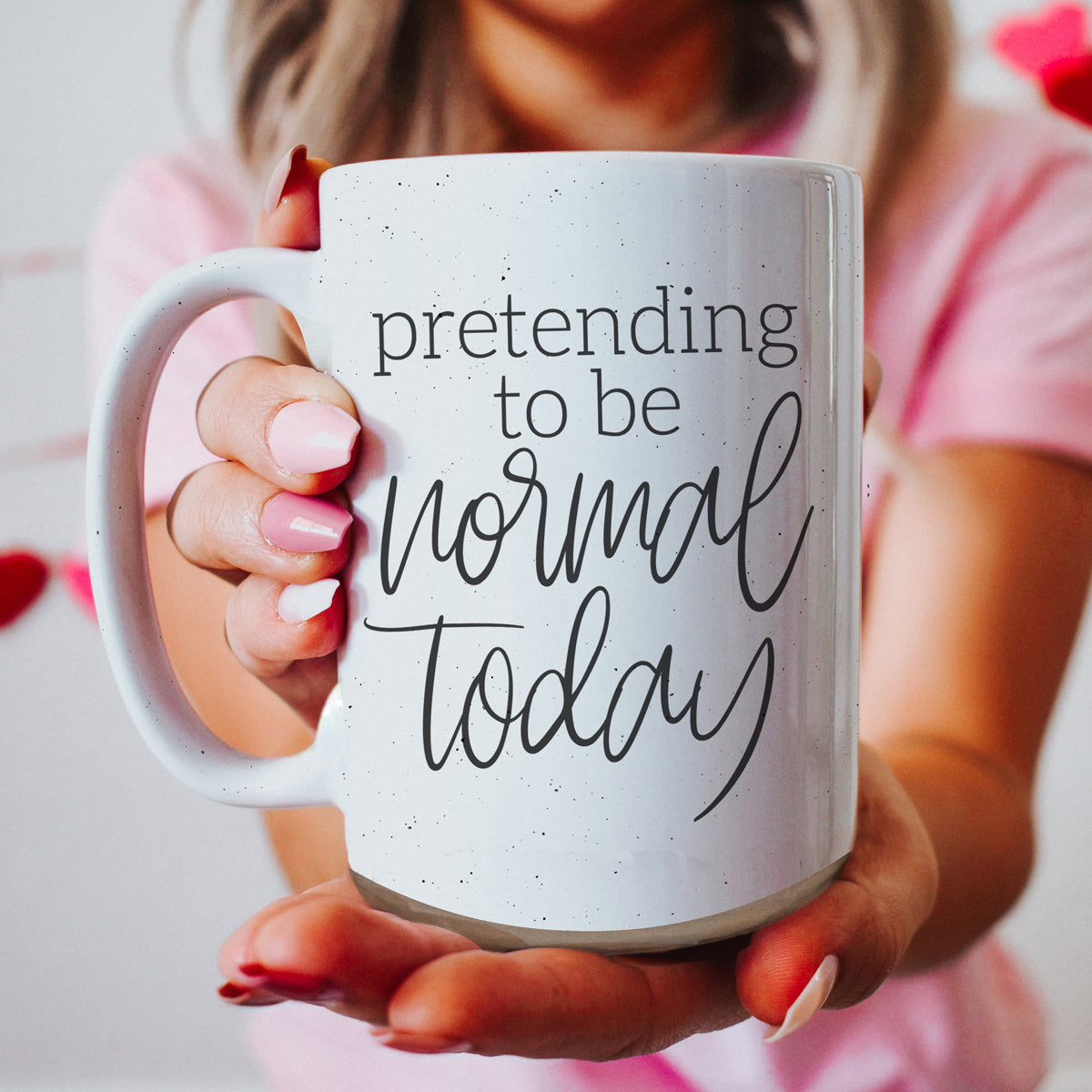 A 16oz off-white ceramic mug with dark speckles, featuring the humorous text 'Pretending to be Normal Today' on both sides.