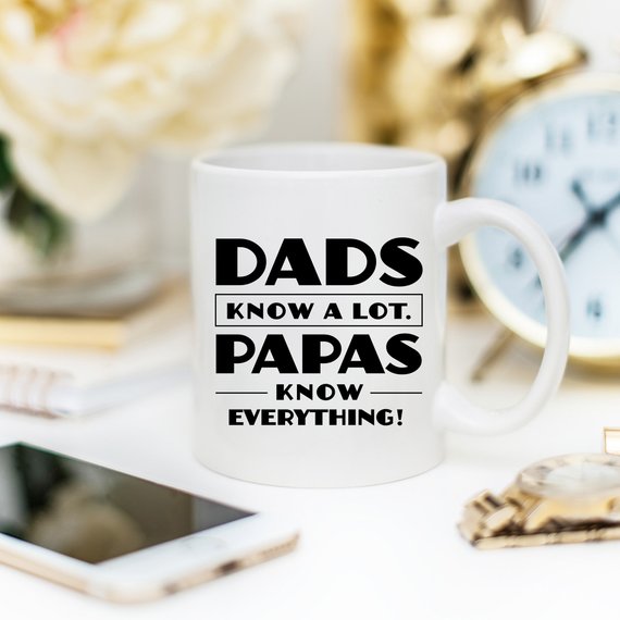 Funny coffee mug with the phrase 'Dads Know A Lot, Papas Know Everything' printed on it, showcasing a humorous design perfect for gifting.