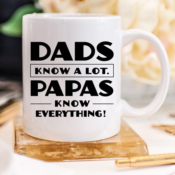 Funny coffee mug with the phrase 'Dads Know A Lot, Papas Know Everything' printed on it, showcasing a humorous design perfect for gifting.