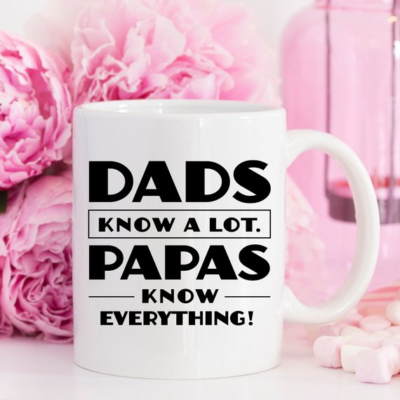 Funny coffee mug with the phrase 'Dads Know A Lot, Papas Know Everything' printed on it, showcasing a humorous design perfect for gifting.