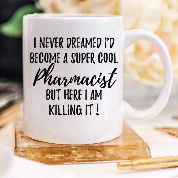 A stylish white ceramic mug designed for pharmacists, featuring a vibrant printed design on both sides, perfect for coffee or tea.