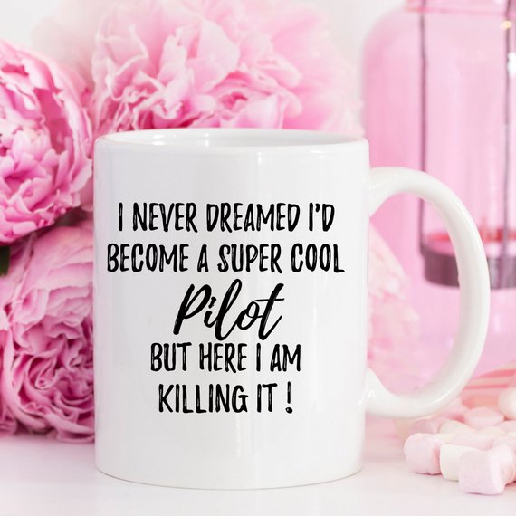 A white ceramic Pilot Mug featuring a vibrant design on both sides, perfect for coffee or tea.