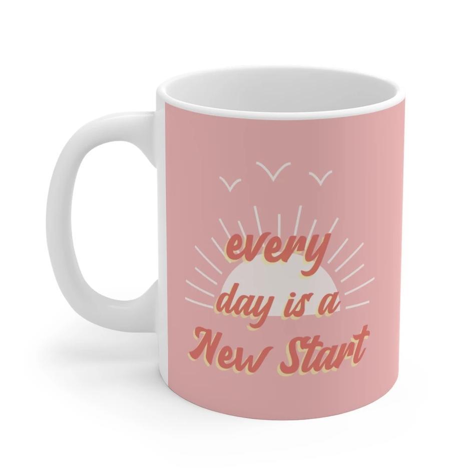 A pink ceramic mug with the phrase 'Everyday Is A New Start' printed on it, featuring rounded corners and a comfortable C-Handle.