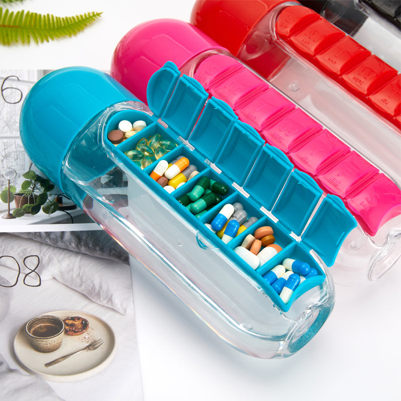 A clear plastic drink bottle with a built-in medicine pills box, featuring seven compartments for pills, ideal for outdoor activities.