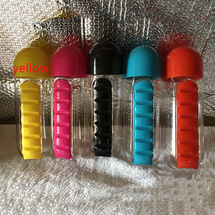 A clear plastic drink bottle with a built-in medicine pills box, featuring seven compartments for pills, ideal for outdoor activities.