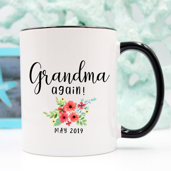 White ceramic mug with 'Grandma Again' design printed on both sides, perfect for pregnancy announcements.