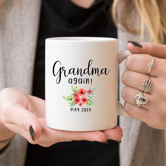 White ceramic mug with 'Grandma Again' design printed on both sides, perfect for pregnancy announcements.