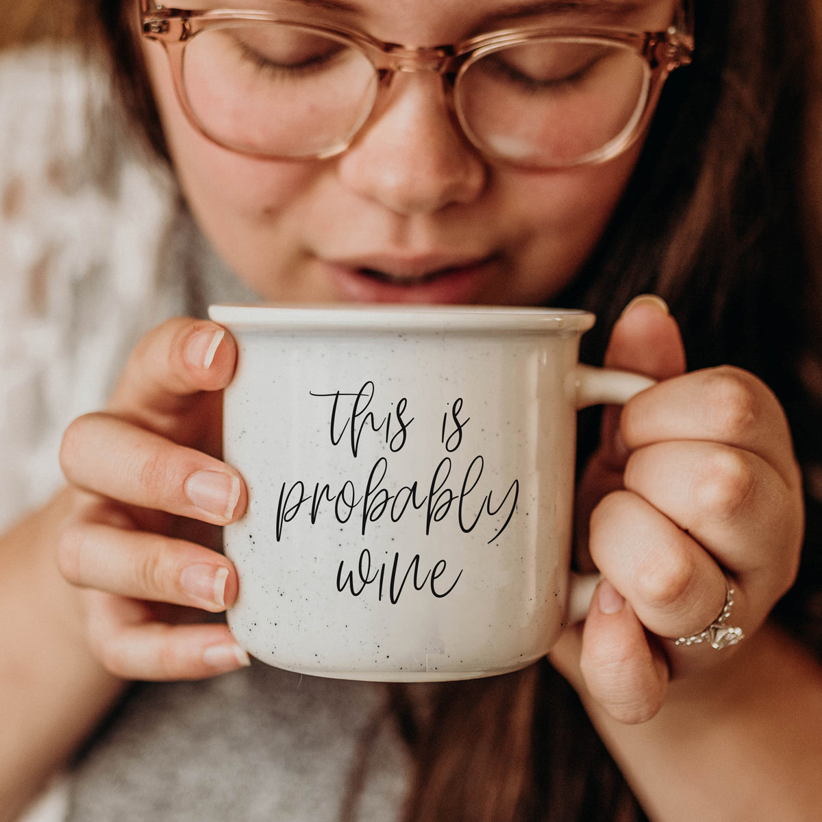 Probably Wine 14.5oz ceramic mug with light ivory glaze and black lettering, featuring a campfire style design.