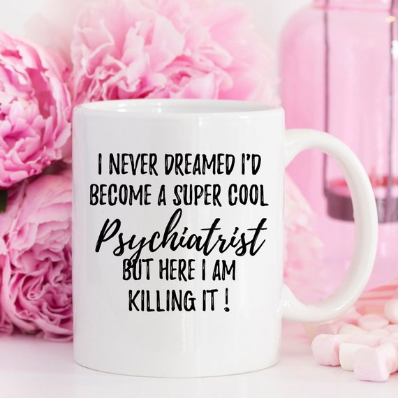 A white ceramic mug featuring a humorous psychiatrist design printed on both sides, perfect for coffee or tea.