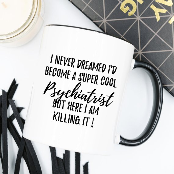 A white ceramic mug featuring a humorous psychiatrist design printed on both sides, perfect for coffee or tea.