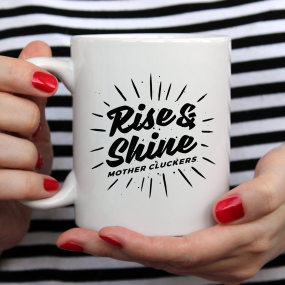 Rise and Shine Mother Cluckers Funny Coffee Mug featuring a humorous design, perfect for coffee or tea lovers.