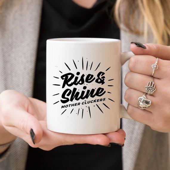 Rise and Shine Mother Cluckers Funny Coffee Mug featuring a humorous design, perfect for coffee or tea lovers.