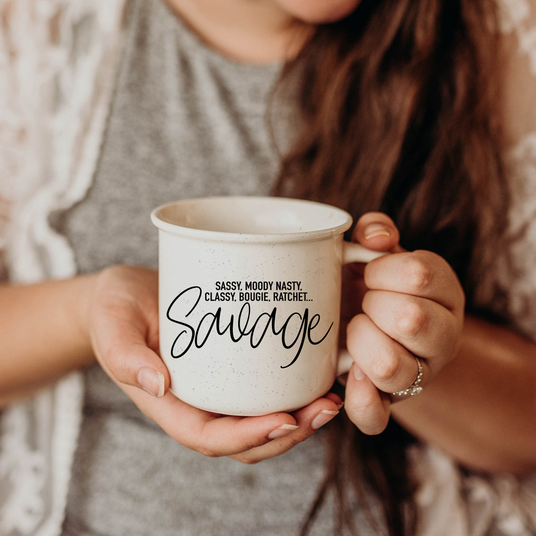 Sassy Savage 14.5oz ceramic mug with black lettering on a light ivory background, featuring a rustic campfire style design.