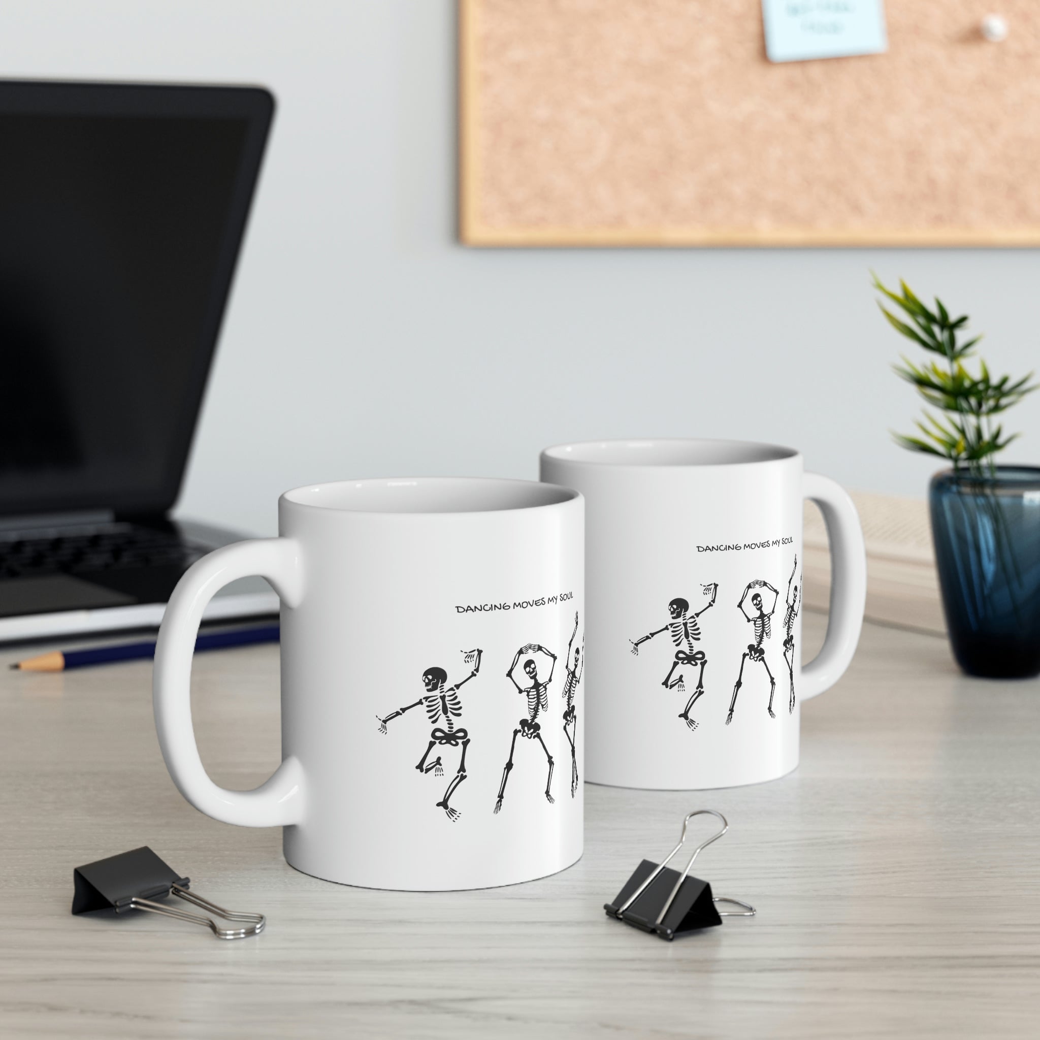 A white ceramic mug featuring a playful design of dancing skeletons, perfect for coffee and tea lovers.