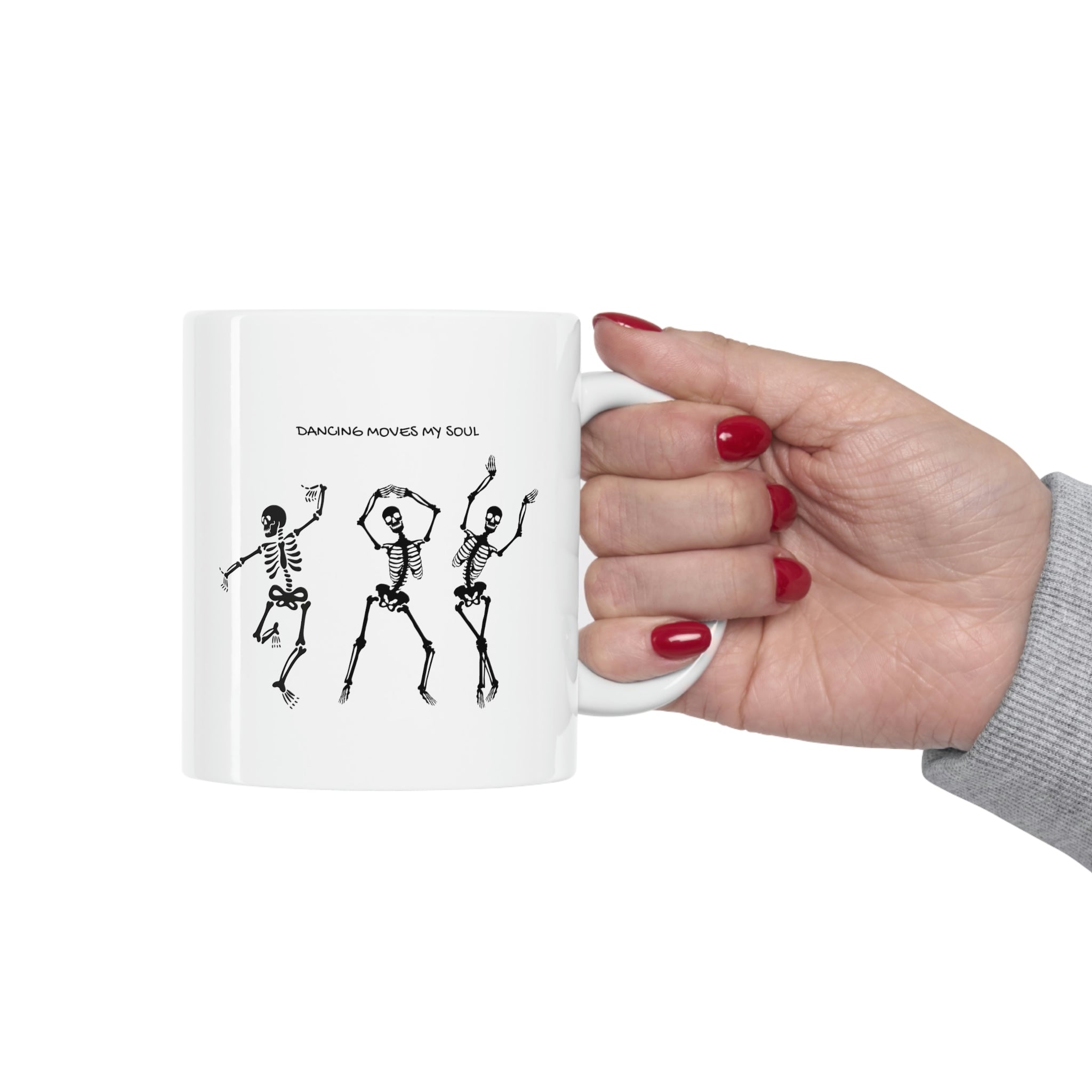 A white ceramic mug featuring a playful design of dancing skeletons, perfect for coffee and tea lovers.