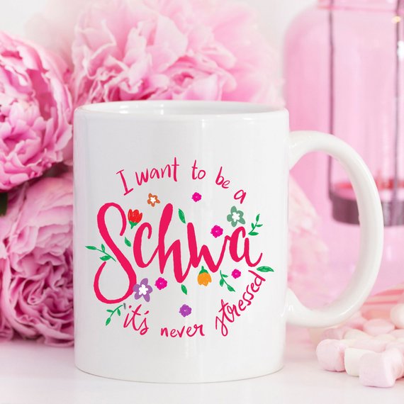 A stylish white ceramic mug featuring a vibrant design celebrating Speech Language Pathologists, available in 11 and 15 oz sizes.