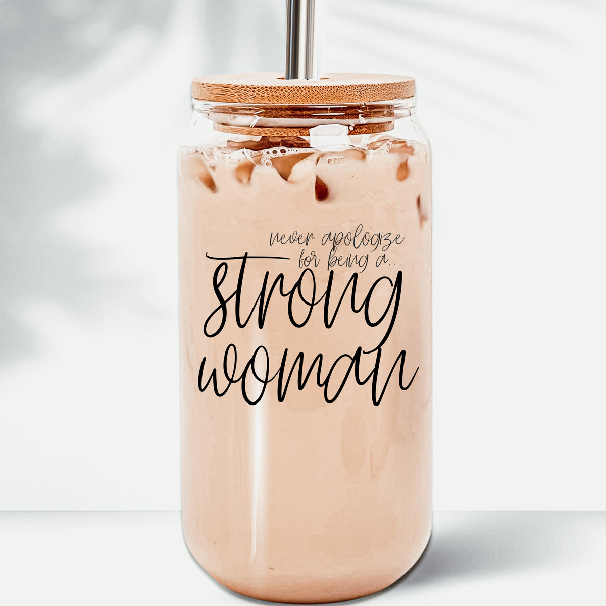 Strong Woman Set featuring glass drinking cups with bamboo lids and stainless steel straws, showcasing a stylish black graphic design.