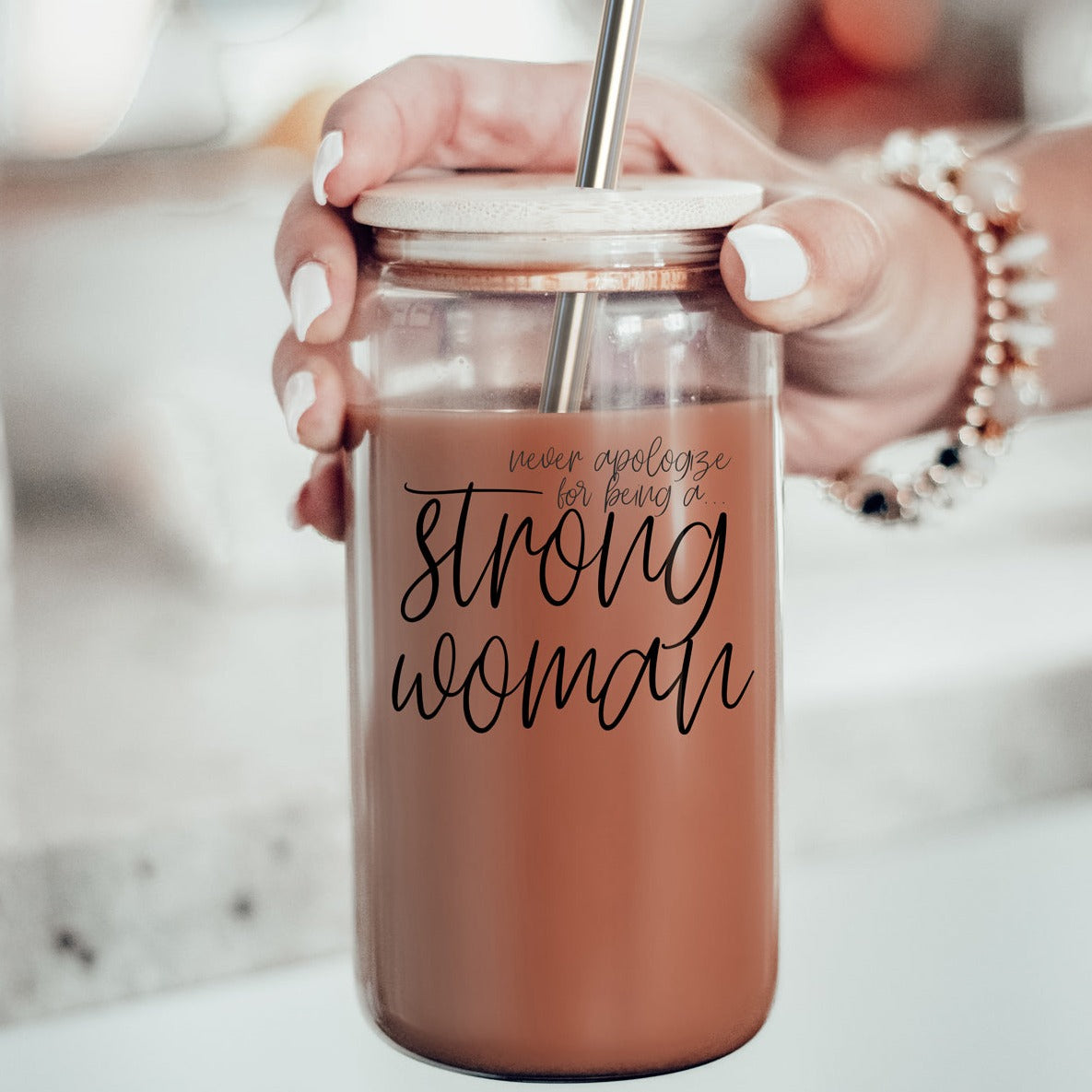 Strong Woman Set featuring glass drinking cups with bamboo lids and stainless steel straws, showcasing a stylish black graphic design.