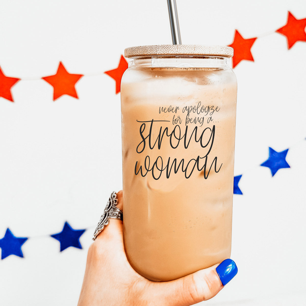 Strong Woman Set featuring glass drinking cups with bamboo lids and stainless steel straws, showcasing a stylish black graphic design.