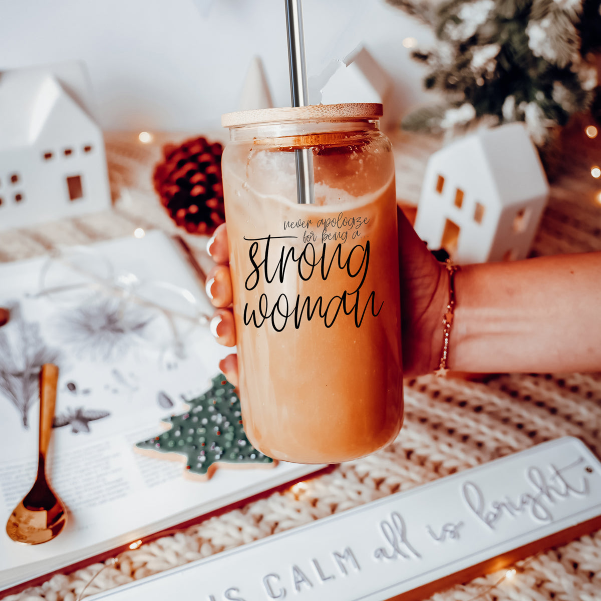 Strong Woman Set featuring glass drinking cups with bamboo lids and stainless steel straws, showcasing a stylish black graphic design.