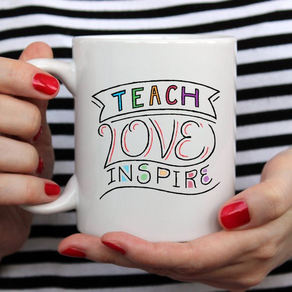 A ceramic coffee mug featuring the phrase 'Teach Love Inspire' in a fun design, perfect for teachers.