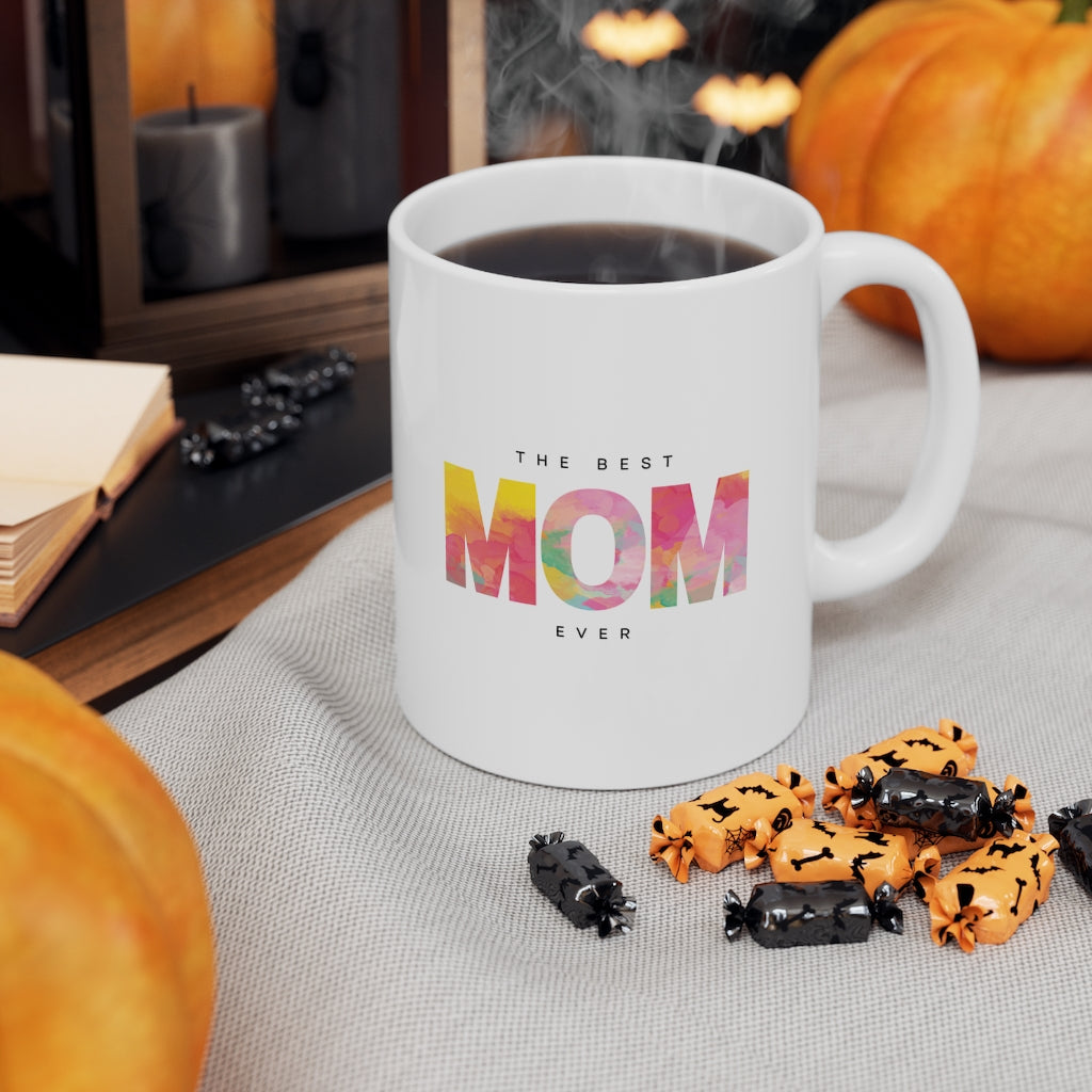 A white ceramic mug with 'The Best Mom' printed on it, featuring a C-handle and rounded corners, ideal for coffee or tea.