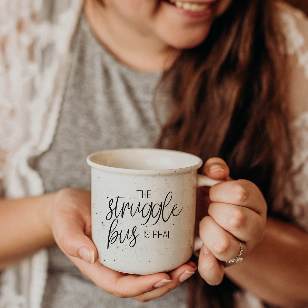 The Struggle 14.5oz ceramic campfire mug with light ivory speckles and black lettering, designed for comfort and style.