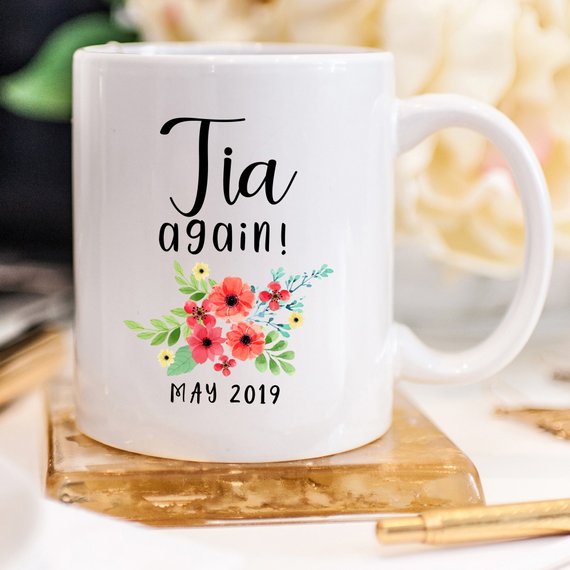 Tia Cup Pregnancy Announcement Cup in white ceramic with vibrant design, showcasing both front and back prints.