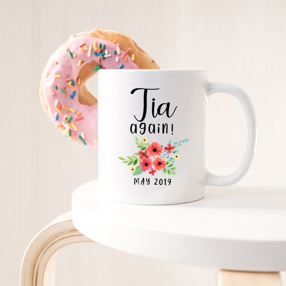 Tia Cup Pregnancy Announcement Cup in white ceramic with vibrant design, showcasing both front and back prints.